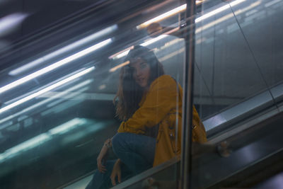 Young woman on escalator