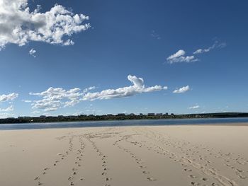 Scenic view of beach against blue sky