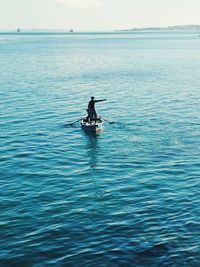 Men on boat in sea against sky