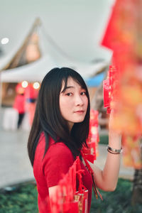 Portrait of young woman standing outdoors