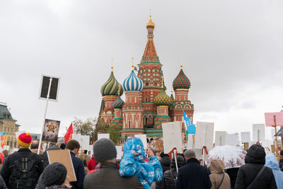 People at temple against sky