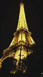 Low angle view of illuminated tower at night