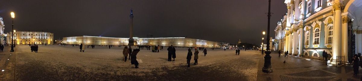 People on illuminated christmas lights at night