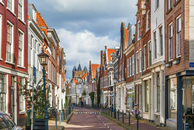 Street amidst buildings in city against sky