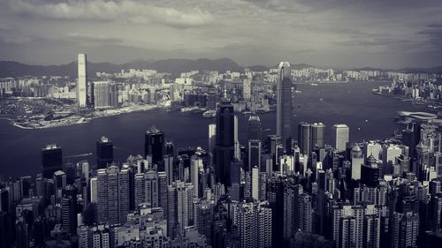 High angle view of cityscape against cloudy sky