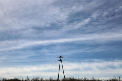 Low angle view of electricity pylon against sky