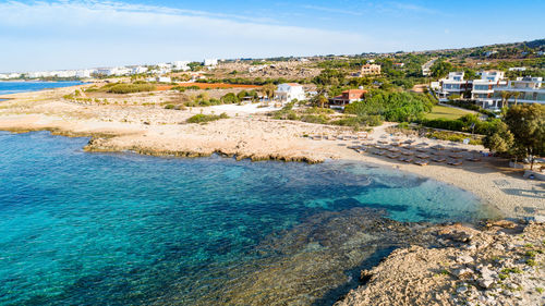 Scenic view of beach against sky in city