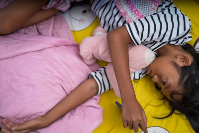 High angle view of baby sleeping on bed