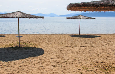 Lifeguard hut on beach against mountains