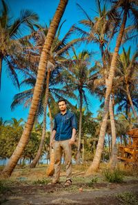 Full length portrait of man with palm tree