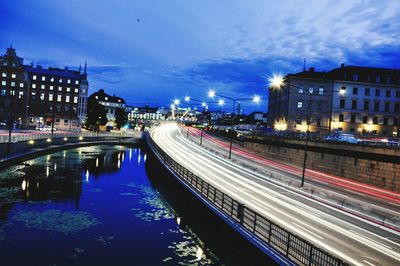 Light trails of moving traffic on road along river