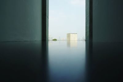 Buildings against sky seen through glass window