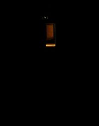 View of illuminated lamp in dark room