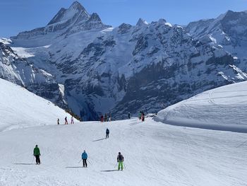 People skiing on snowcapped mountain