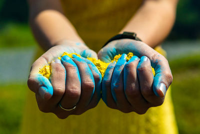 Midsection of woman holding powder paint during holi festival