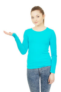 Portrait of smiling young woman standing against white background