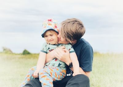 Rear view of father and daughter on field