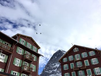 Low angle view of building against cloudy sky