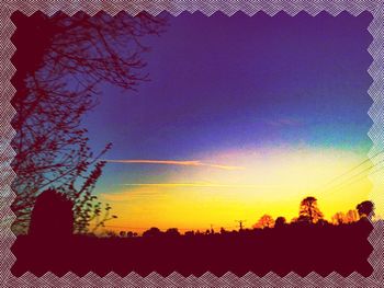 Low angle view of silhouette trees against sky at sunset