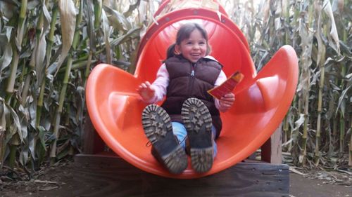 Smiling boy sitting on plants