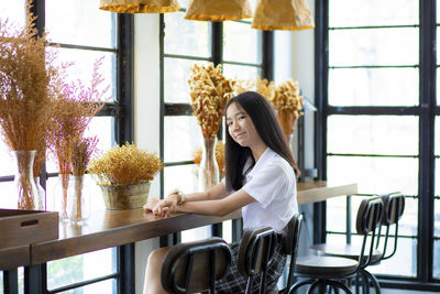 Woman sitting on chair at table