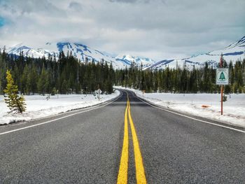 Road passing through cloudy sky