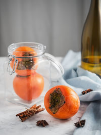 Close-up of fruit with glass jar on table