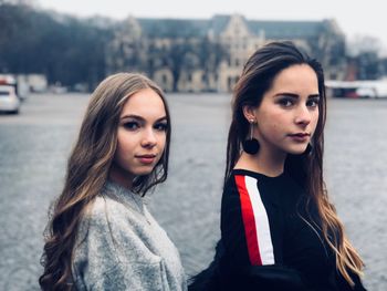 Portrait of beautiful woman standing in city