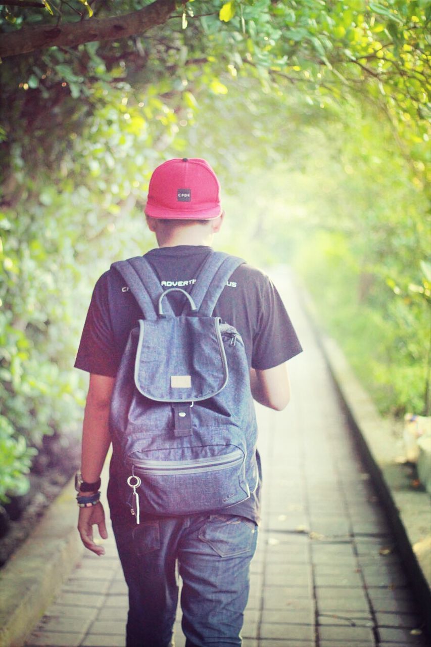 lifestyles, rear view, leisure activity, casual clothing, tree, standing, men, full length, walking, person, day, three quarter length, outdoors, the way forward, focus on foreground, jacket, footpath, street