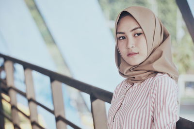 Close-up of woman wearing hijab while standing on corridor