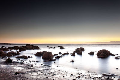 Scenic view of sea against sky at sunset