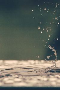 Close-up of raindrops on sea against sky