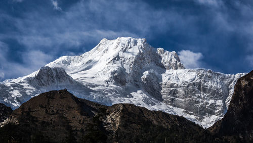 Scenic view of snowcapped mountains against sky