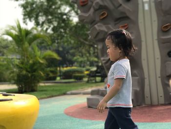 Side view of girl walking at playground