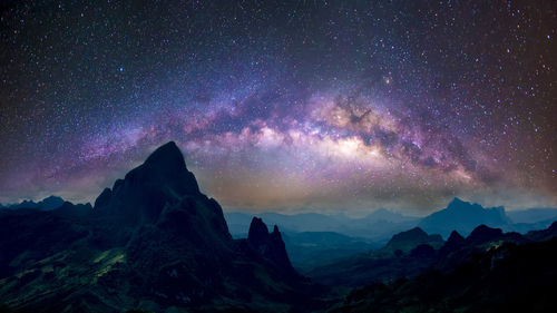 Scenic view of mountains against sky at night