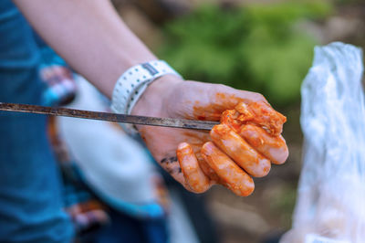 Close-up of hand holding meat