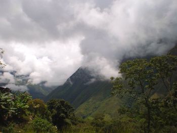 Scenic view of mountains against cloudy sky