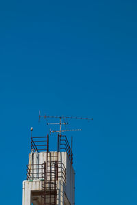 Low angle view of building against clear blue sky