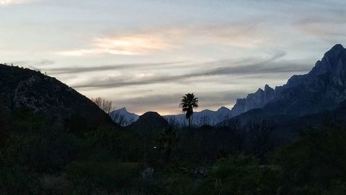 Scenic view of mountains against sky at sunset