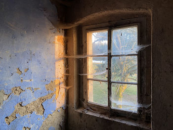 Abandoned building seen through window