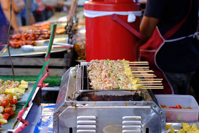 Midsection of preparing food at market stall