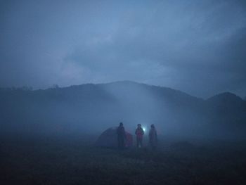 People on mountain road against sky