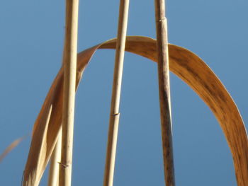 Low angle view of metallic structure against clear blue sky