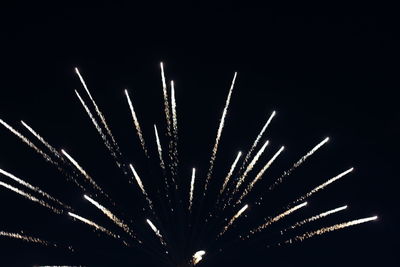 Low angle view of firework display at night