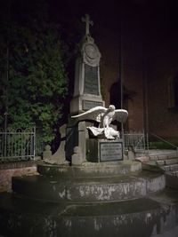 Low angle view of statue against built structure