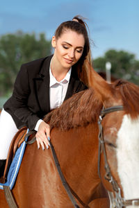 Portrait of young woman with horse