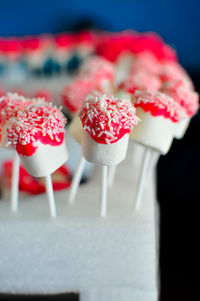 Close-up marshmallow dipped chocolate and sprinkled with white chocolate rice.