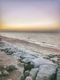 Scenic view of beach against sky during sunset