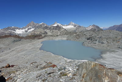 Scenic view of mountains against clear blue sky