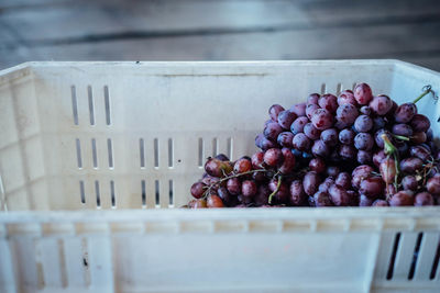 Close-up of red grapes in crate